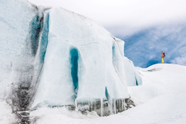 Photographie d'un homme près d'un glacier